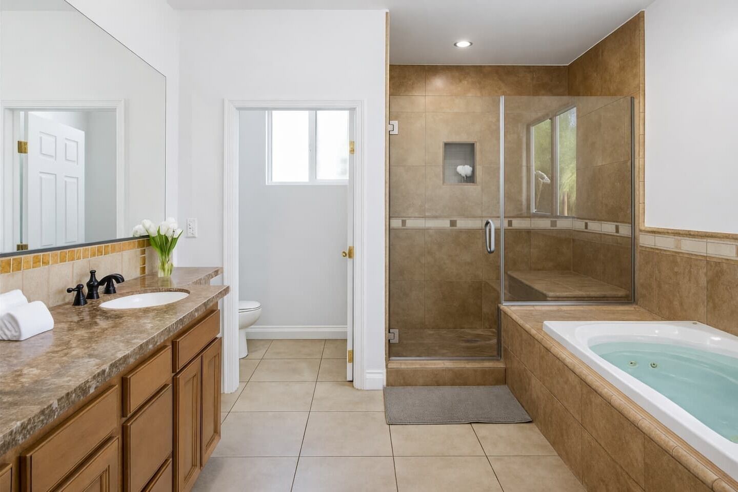 Primary ensuite bathroom with jetted tub for a spa-like feel