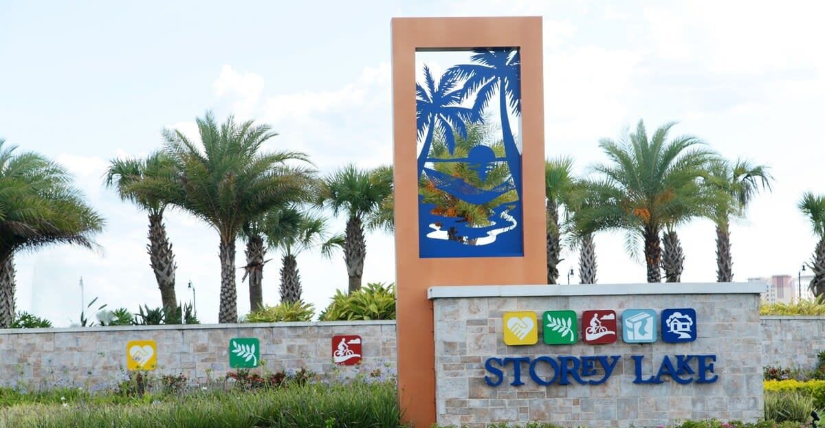 A sign for Storey Lake with palm trees and a tropical mural.