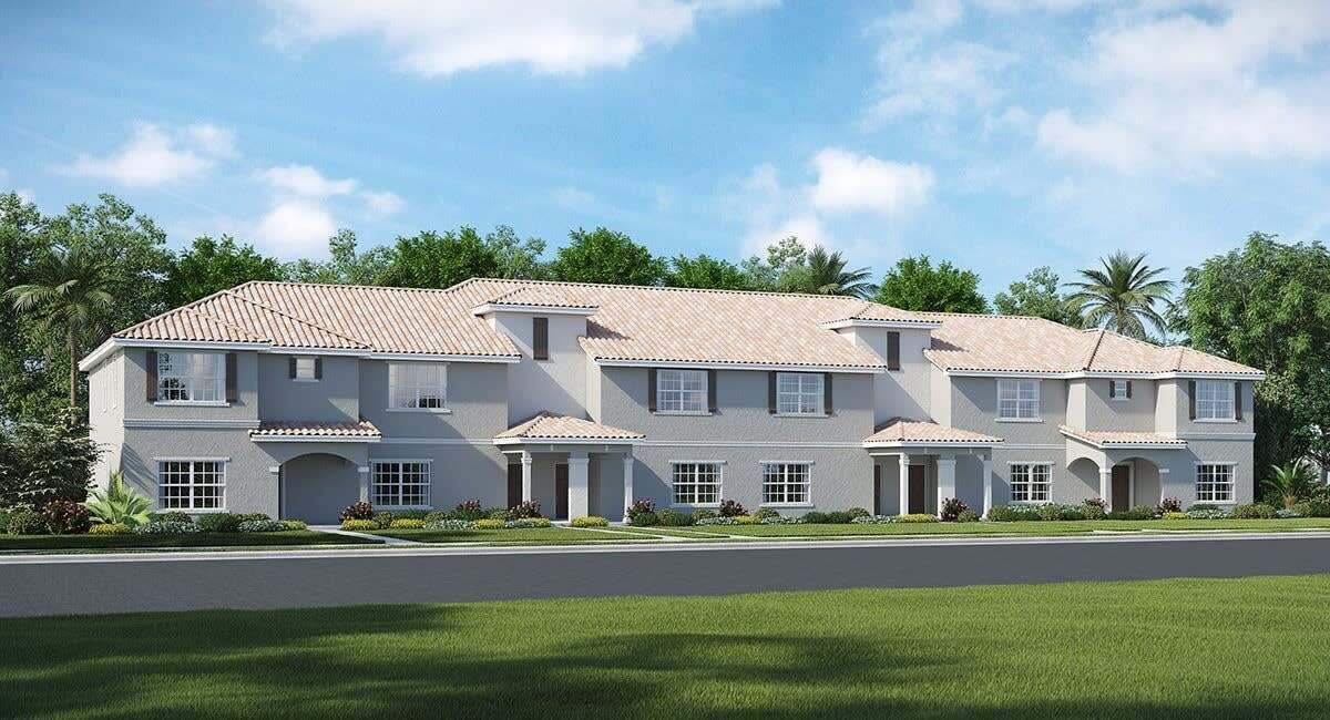 A two-story house with a tiled roof, multiple windows, and a well-maintained lawn.