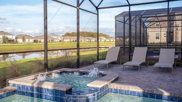A hot tub area with a view of a residential neighborhood.