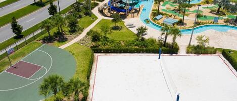 An aerial view of a recreational area with a basketball court, a swimming pool, and various play structures.