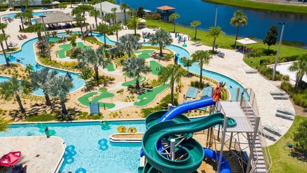 A water park with a large pool, slides, and a golf course. - Gorgeous 2Bd Apto Close to Disney @ Storey Lake 404 3191 (Kissimmee)