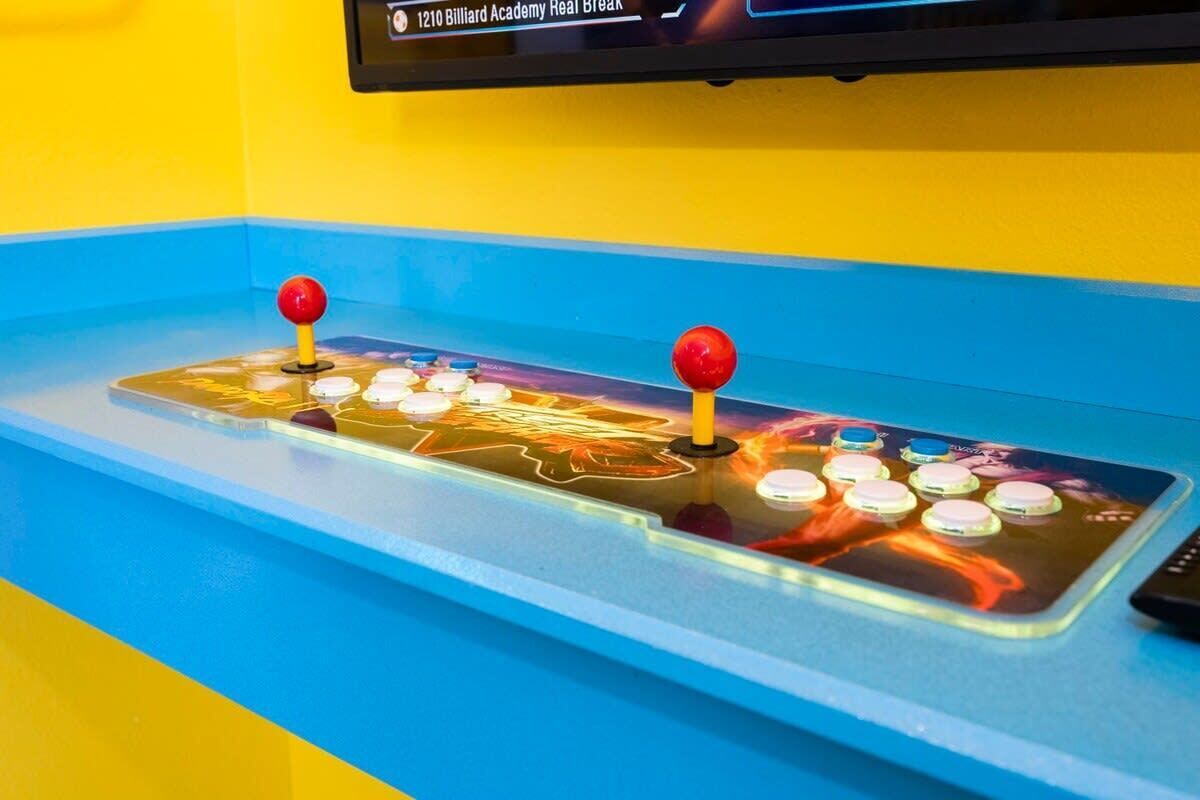 A billiards table with a digital display above it.