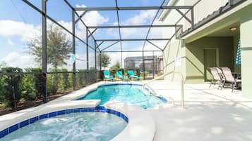 Relax by the pool surrounded by lush vegetation and shaded walkways.