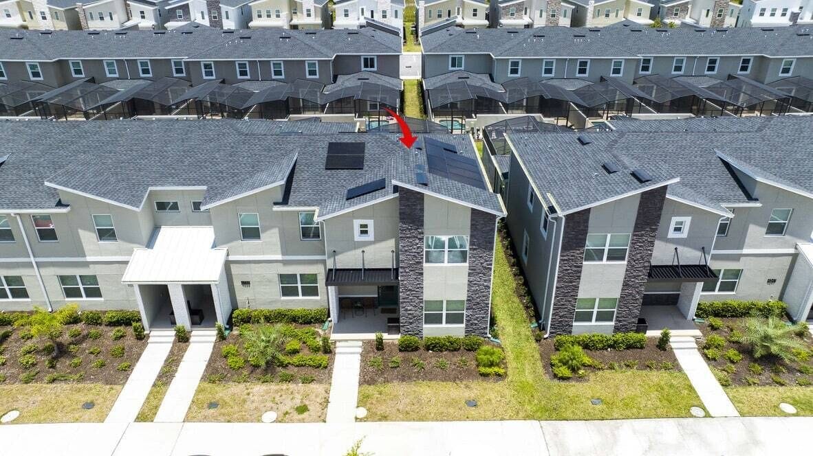 A residential building with a modern design, featuring a central courtyard and multiple balconies.