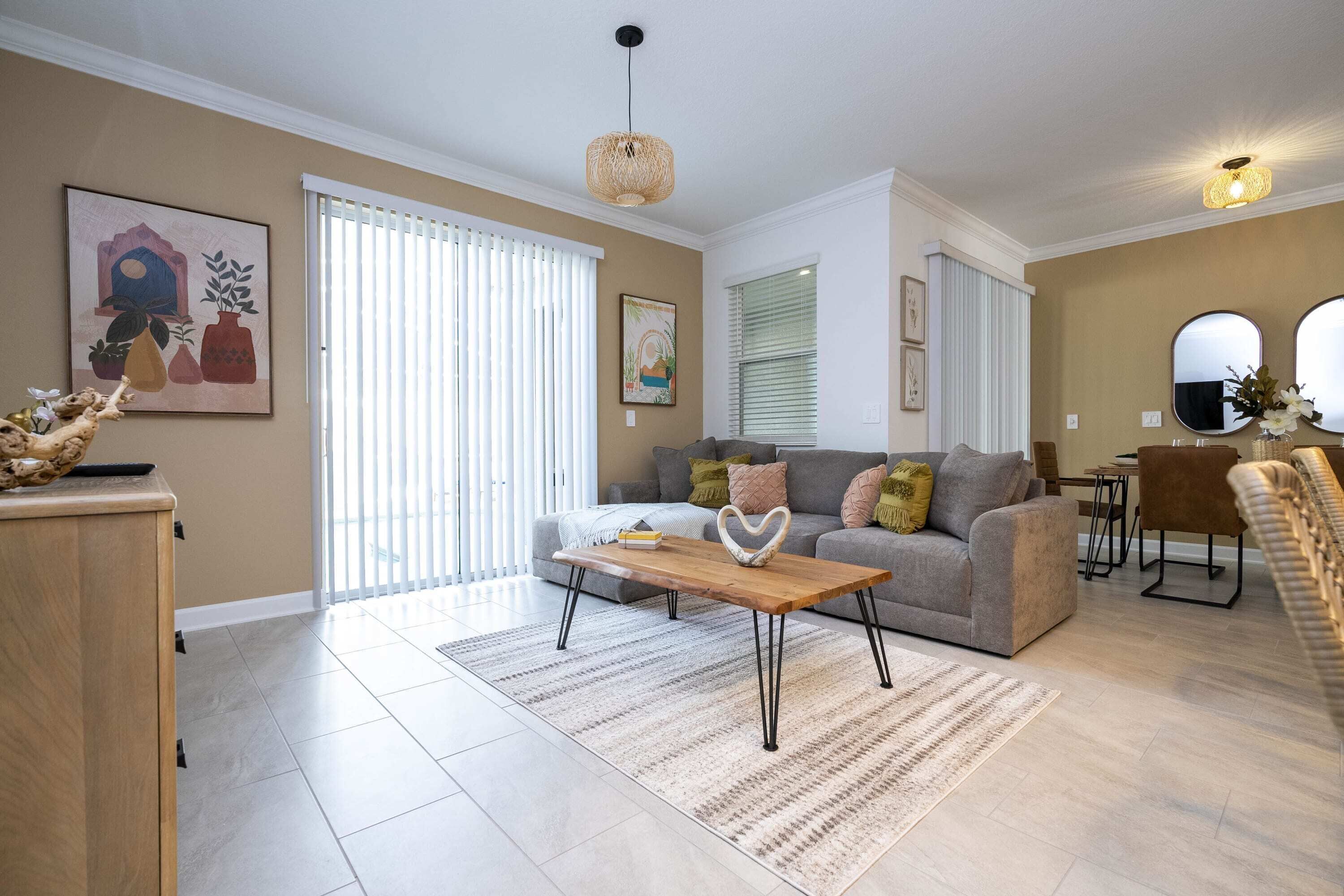 A modern living room with a sofa, coffee table, and decorative items.