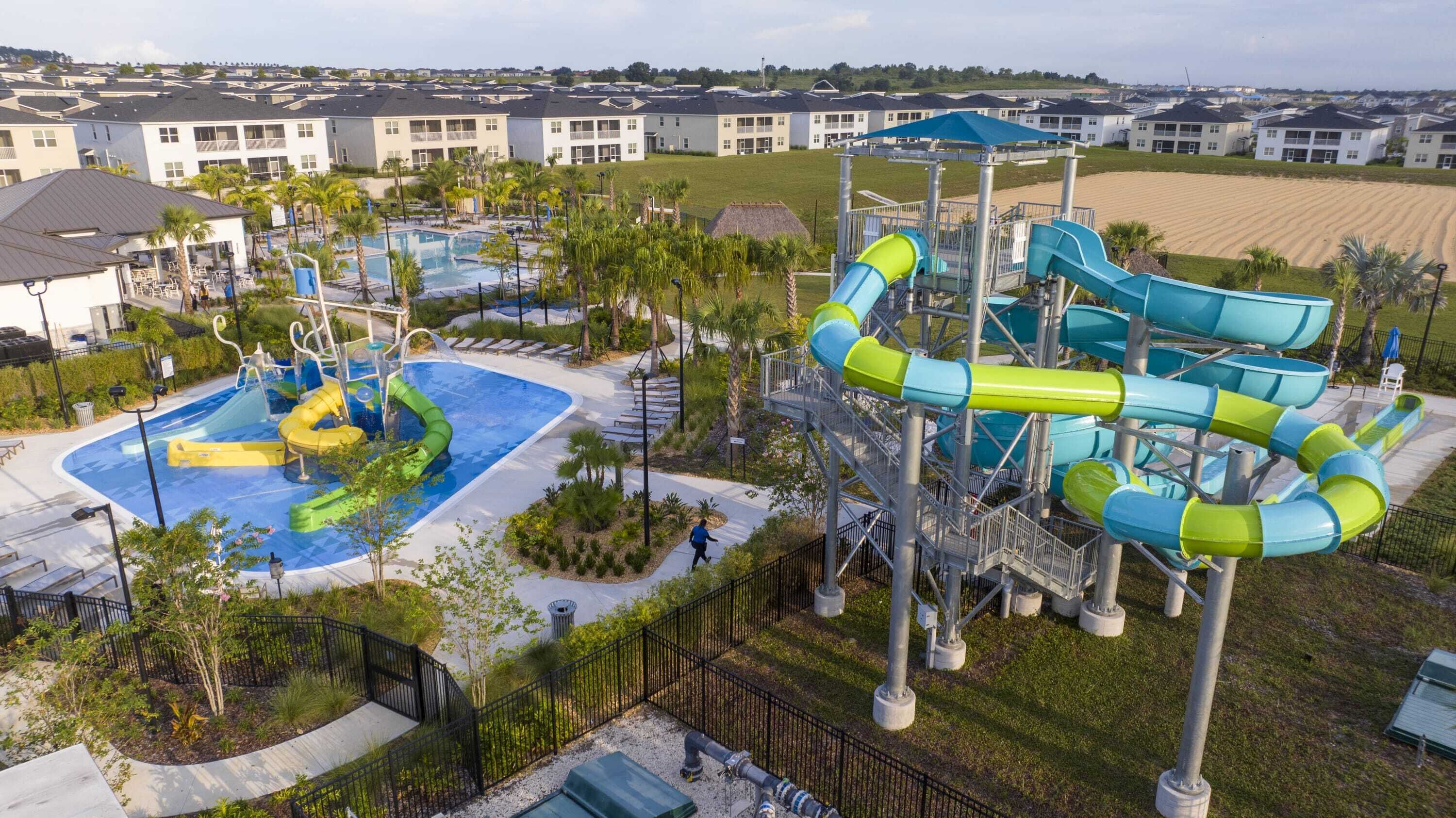A water park with multiple slides and a pool area, surrounded by residential buildings.