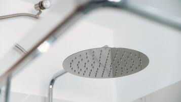A modern showerhead with a curved design and a single handle.