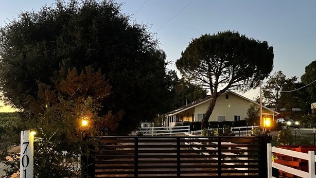 A gated driveway leading to a house with a number sign '7010'. - Wine Country Trail, View, Gated property, Detached Studio & Private View Patio, (Paso Robles)