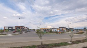 A commercial area with a parking lot, a dental clinic, a car wash, and a gas station.