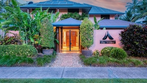 A hotel entrance with a gated driveway, lush tropical landscaping, and a sign reading "Chez Willow." - Villa 3 @ Chez Willow (Port Douglas)