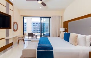 Relax in comfort with a large bed and a seating area, featuring a flat-screen TV and a window with a view.