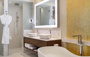 Relax in a spacious bathroom with a bathtub, two sinks, and a walk-in shower.