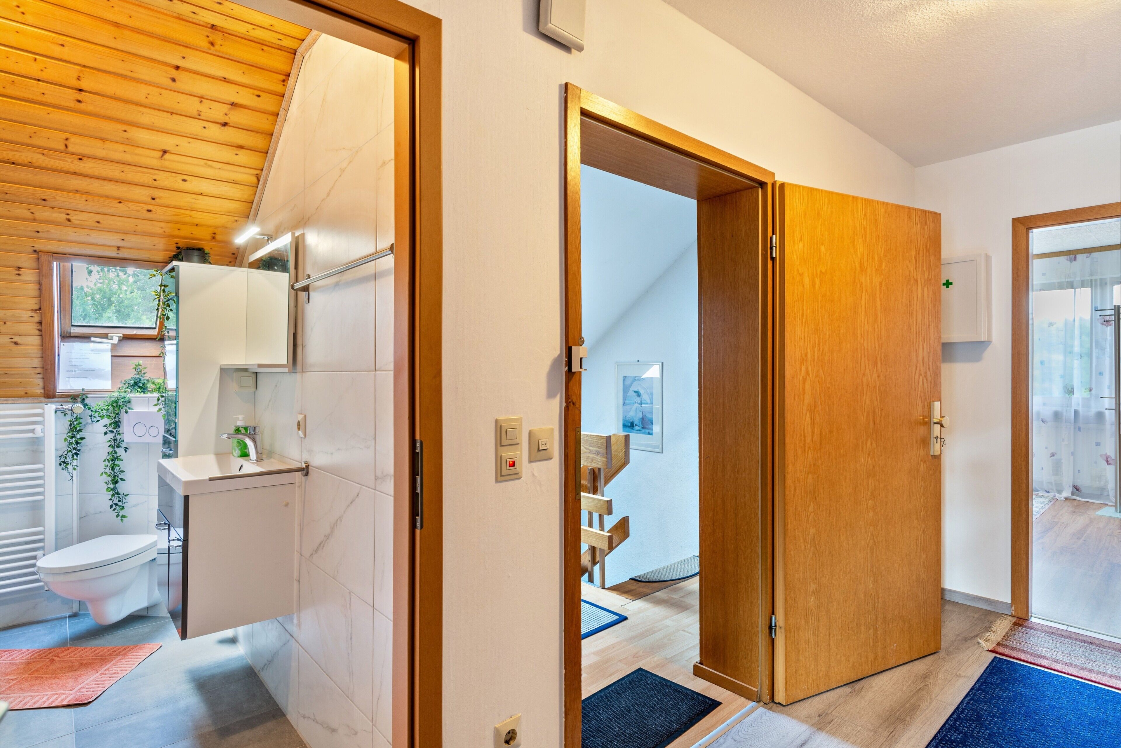 A modern bathroom with a toilet, sink, and shower area.