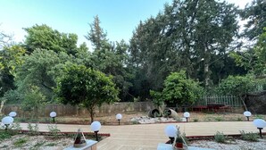 A landscaped outdoor area with steps leading up to a viewing platform, surrounded by trees and lamp posts. - Zebrano Apartment in Kallithea Rhodes (Rhodes)