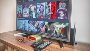 A television displaying a Netflix interface with various show thumbnails. - Butler's Bnb E Trees Residences Qc Phil (Quezon City)