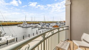 A balcony with a view of a marina, featuring boats docked at the pier. - Hope Harbour Hotel Apartments (Hope Island)