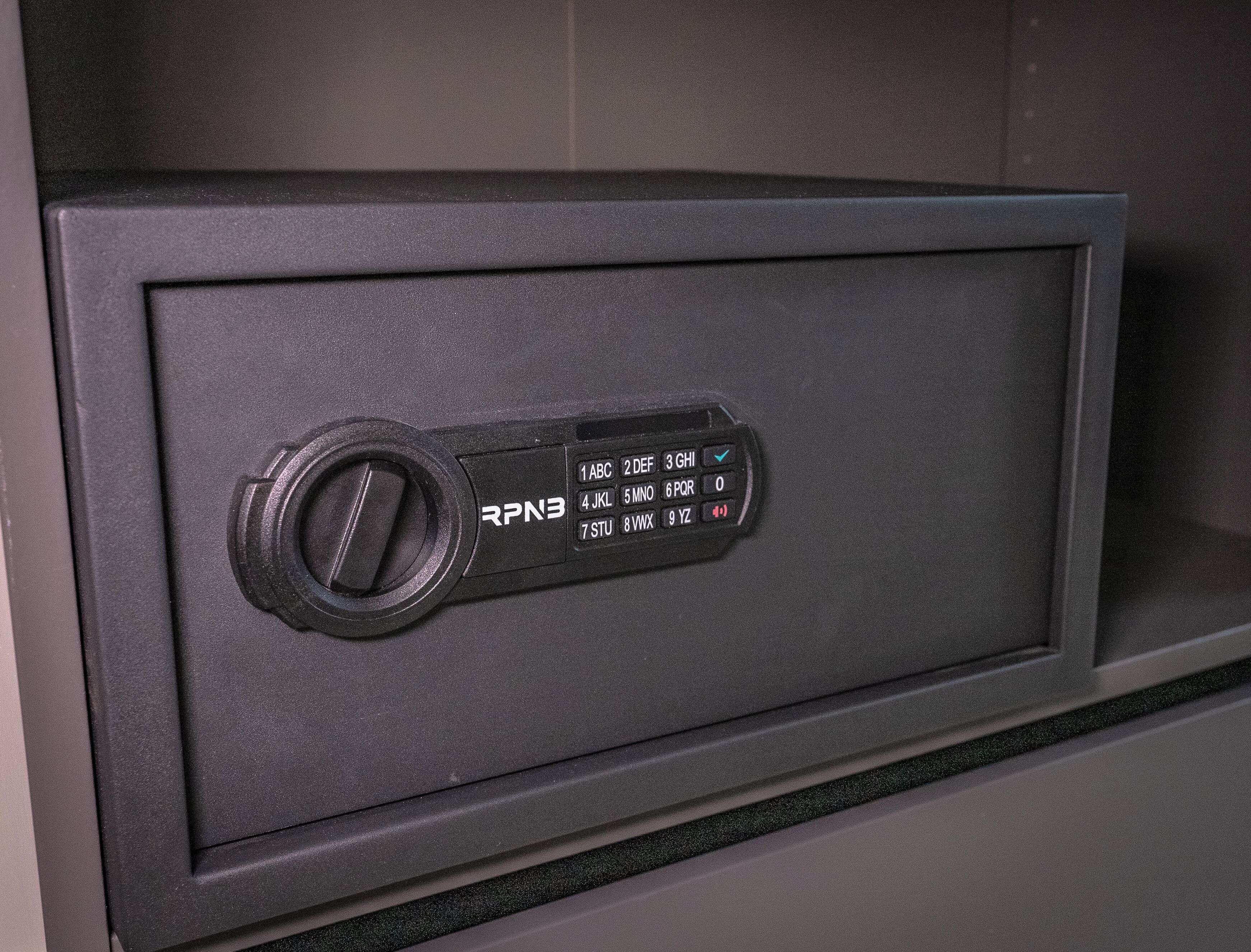 A safe with a combination dial and a keypad.