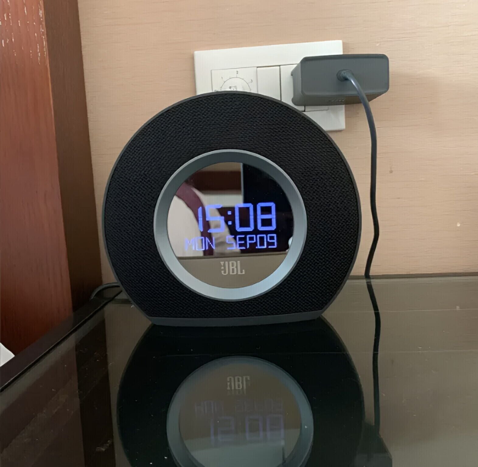 A digital clock with a circular design, displaying the time and date.