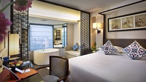 A hotel room with a bed, a desk with a lamp, a chair, a bathroom with a sink, and a view of the city. - SSAW Boutique Hotel Shanghai Hongkou (Shanghai)