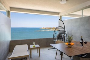 Enjoy a meal or social gathering on this balcony with a clear view of the sea and distant shoreline.