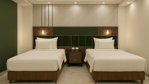 A hotel room with two beds, a nightstand, and a wall-mounted panel. - Porto Said Elegance Where Style Meets the Sea (Al-Manasrah)