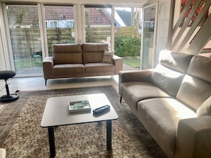 A living room with a sofa, a coffee table, and a patterned rug.