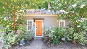 A house with a front door, a small porch, and a pathway leading to the entrance.