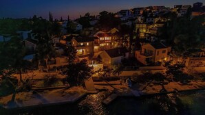A residential area with houses, a dock, and a body of water. - Villa Captains House 2 (Rogoznica)