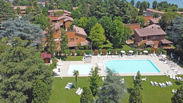 An aerial view of a resort with multiple buildings, a large swimming pool, and lush greenery. - Residence Punta Gro 2 5 by Wonderful Italy (Sirmione)