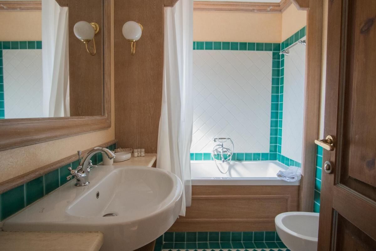 A bathroom with a sink, bathtub, and toilet.