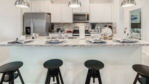 A modern kitchen with white cabinets, stainless steel appliances, and pendant lighting. - Windsor Island 7br, Free Pool Heat, 5min Walk To L (Davenport)