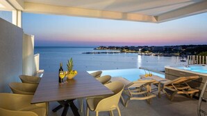 A terrace with a view of the sea, a table with chairs, and a hot tub. - Salt&soul Residence Three-bedroom Apartmant (Povljana)