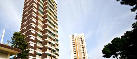 A tall, modern apartment building with a distinctive zigzag pattern on its facade.