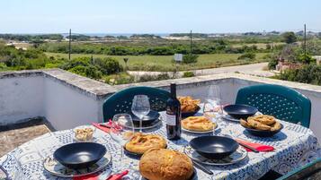 Enjoy a meal on the outdoor dining table, set with fine china and a beautiful view of the surrounding countryside.