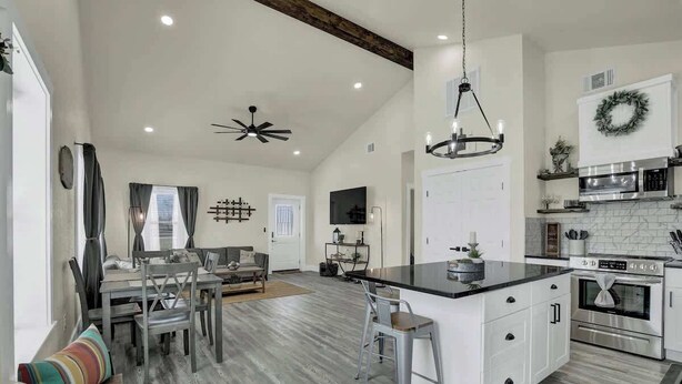 A spacious kitchen with a large island, white cabinetry, and stainless steel appliances. - Hill Country Hideaway With Fire Pit and Hot Tub! (Fredericksburg)