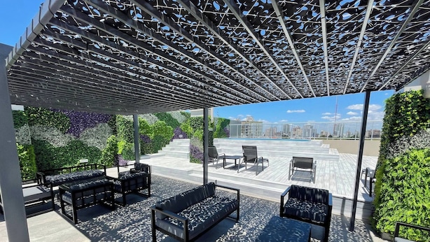 A rooftop terrace with outdoor seating, a pergola, and a city view. - Brand New Apartment In Caballito (Buenos Aires)