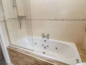 A modern bathroom with a glass-enclosed shower, a freestanding bathtub, and a tiled floor. - Millhouses Hideaway (Sheffield)
