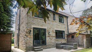 A stone house with a large window and a small porch area. - Millhouses Hideaway (Sheffield)
