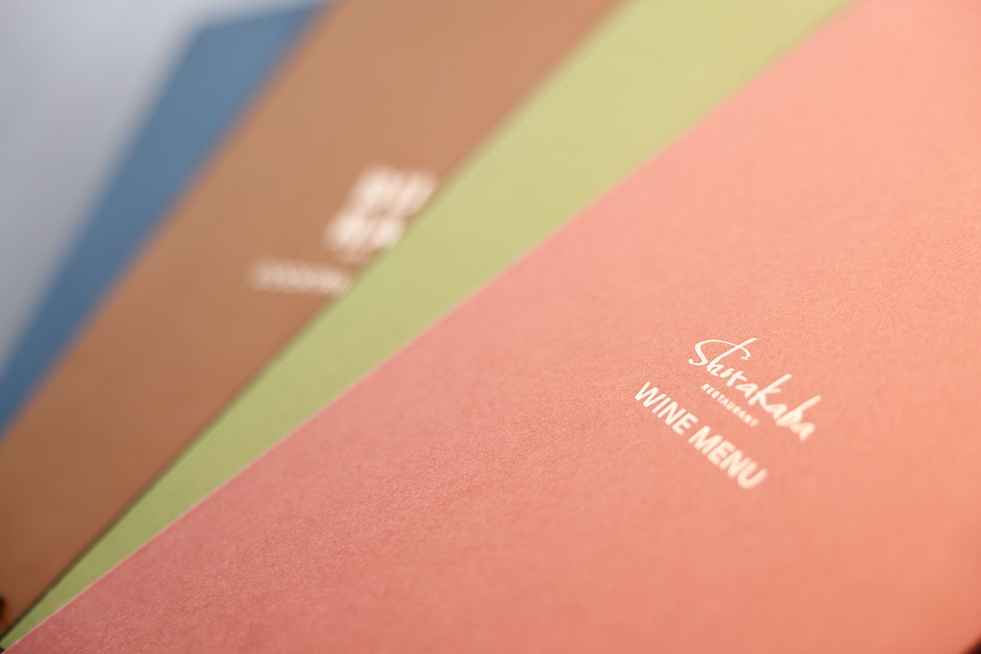A menu with the text "Shirakaba" and "VINE MENU" on a pink background.