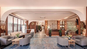 A spacious lobby with a reception desk, sofas, and a marble floor. - Riverside Hotel (Vientiane)