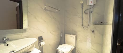 A bathroom with a sink, toilet, and shower.