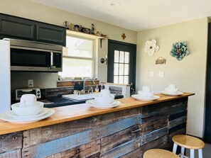 Fridge, microwave, coffee/tea maker, cookware/dishes/utensils