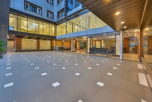 Welcome to our hotel lobby, featuring a spacious open area with a patterned floor, reception desk, and seating area with views into the interior spaces.