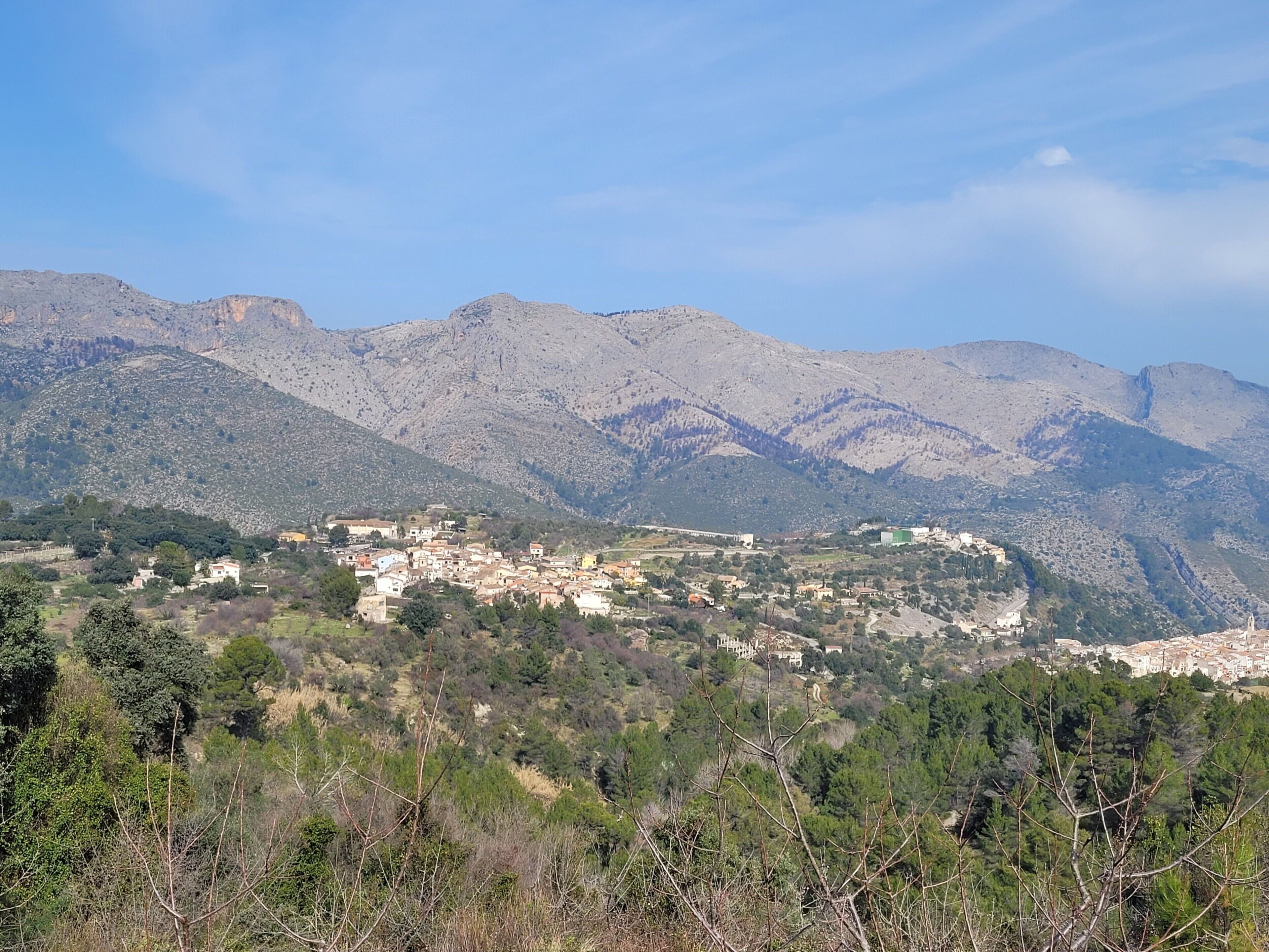 A mountainous landscape with a town nestled in the valley.