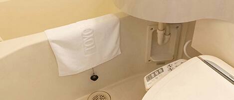 A bathroom with a white sink, a bathtub, and a toilet.