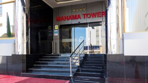 A building entrance with a sign reading "MANAMA TOWER" and a staircase leading up. - oyo 123 (Manama)