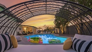 A pool area with a canopy, lounge chairs, and a view of the house. - Casa Paradiso|Private Pool, Firepit & Putt. Green (Scottsdale)