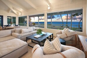 Relax in this spacious living room with ocean views and plush sofas.