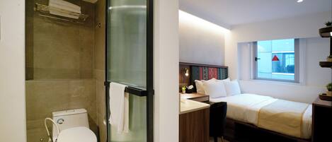 A modern hotel room with a shower, toilet, bed, bedside table, and a window with a view.